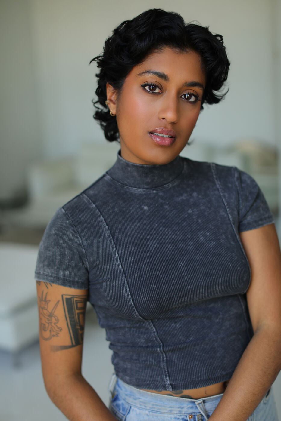 Headshot of Uma Paranjpe — three-quarter pose in grey mock-neck