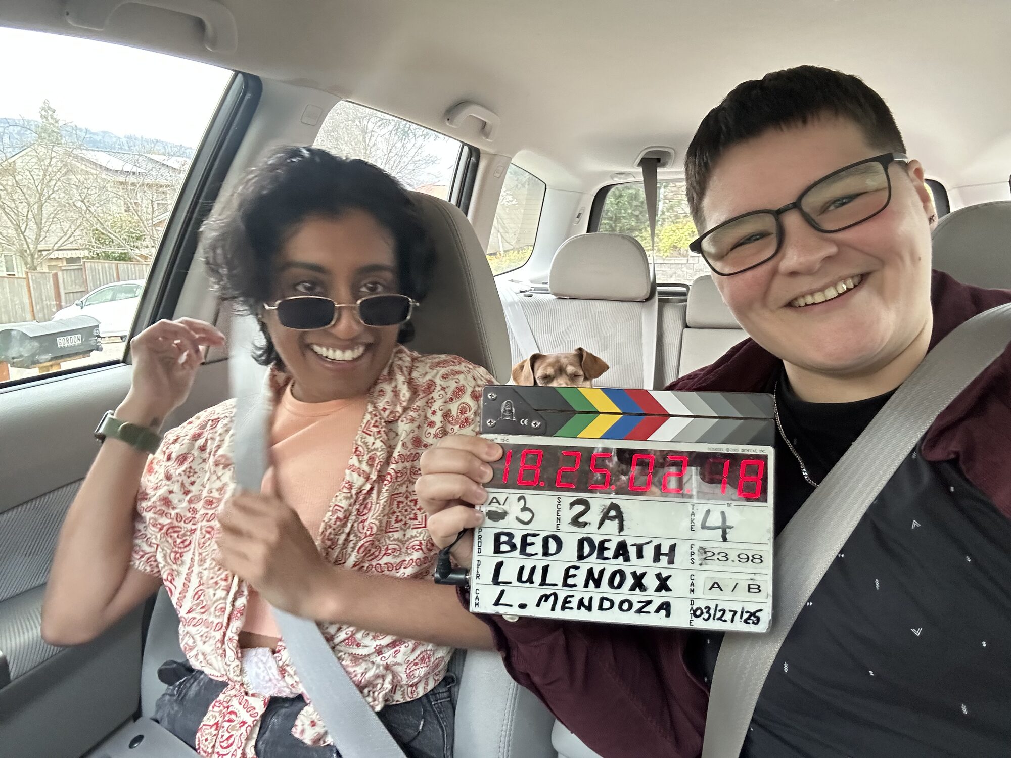 Uma on a film set with a slate for Bed Death