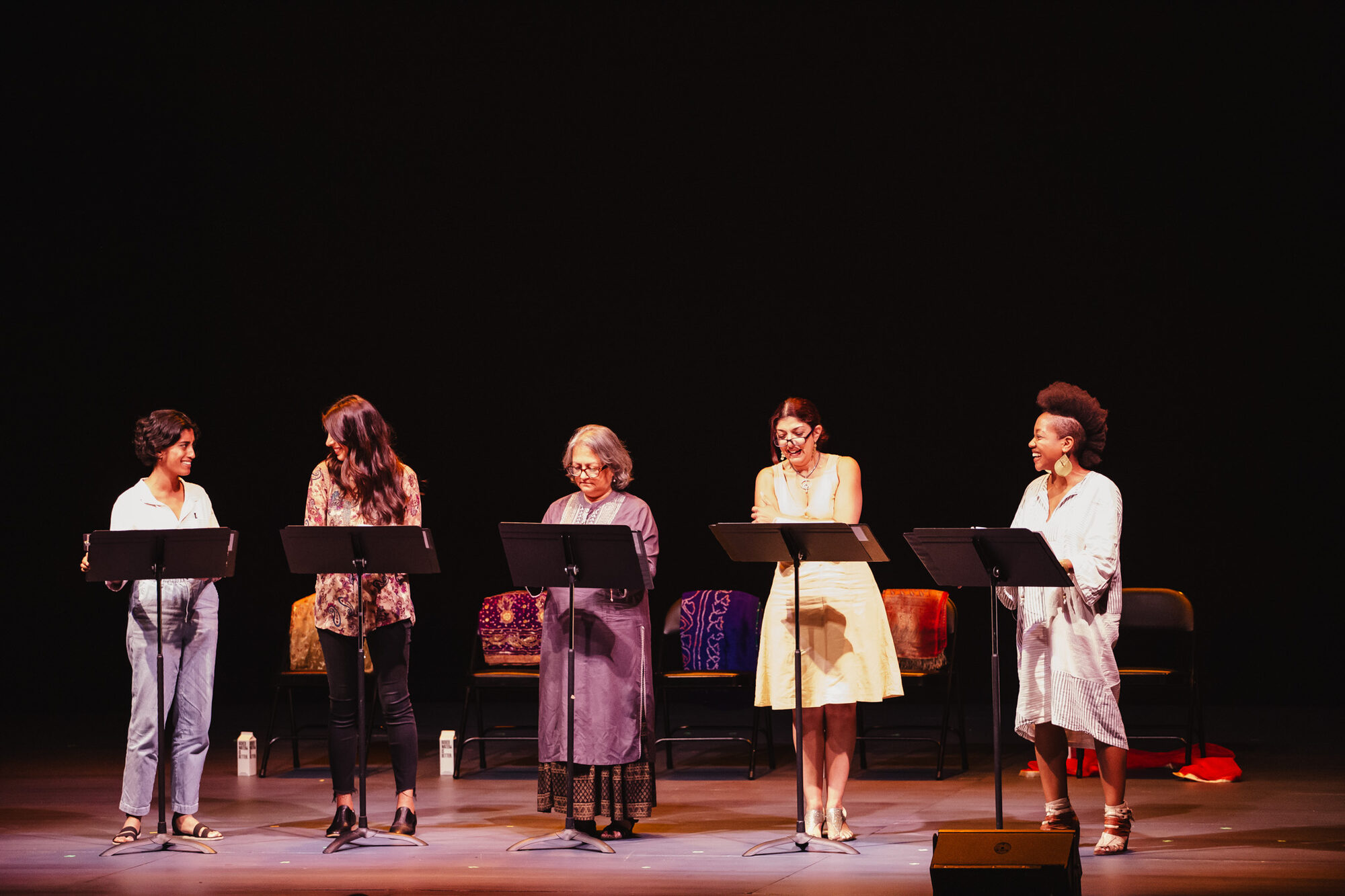 Five actors at music stands during a reading