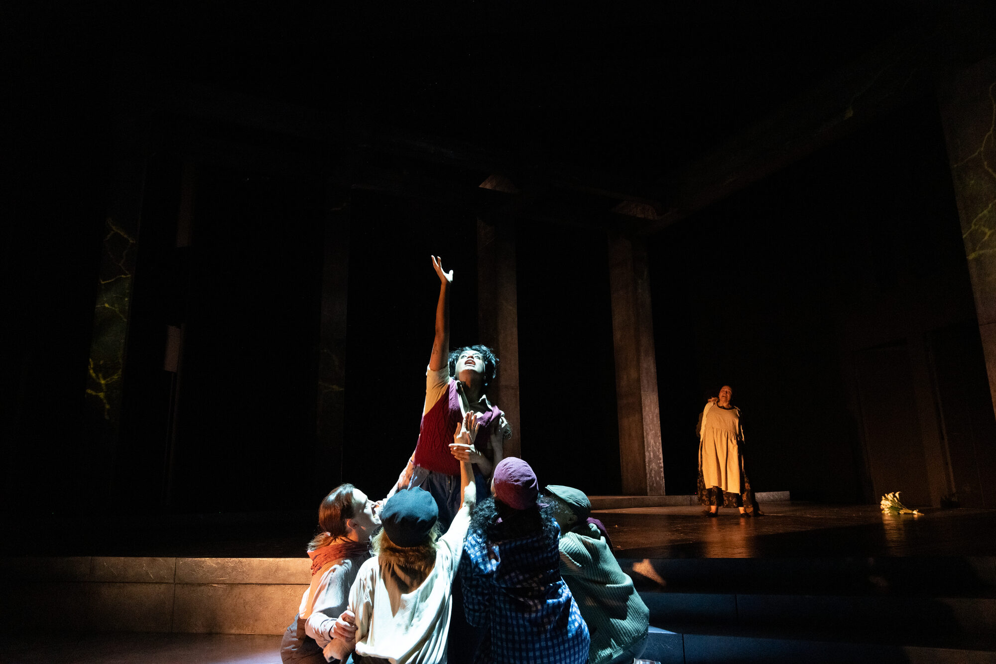 Reaching upward in a dramatic stage scene