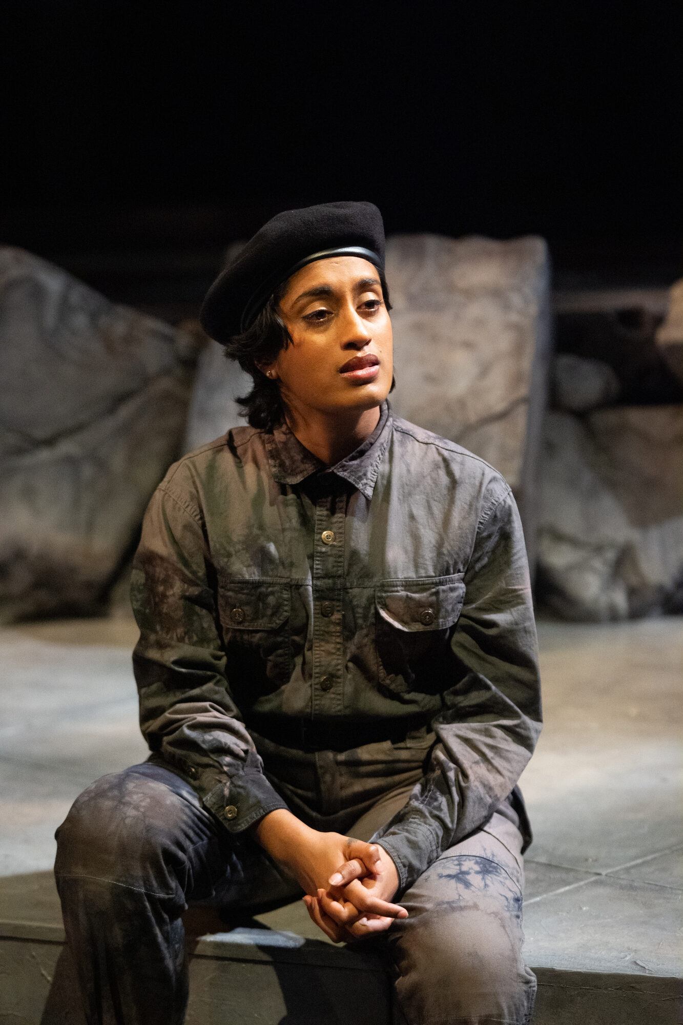 Production still wearing a beret in tango of a crumbling wall