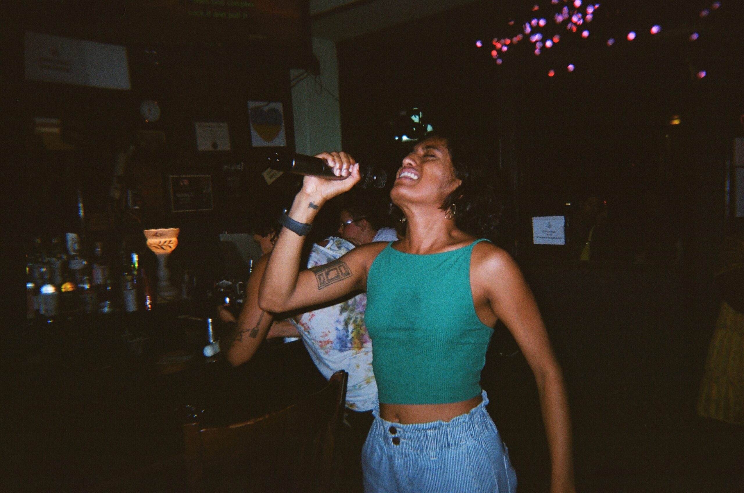 Uma Paranjpe singing karaoke at Ginger's Bar.